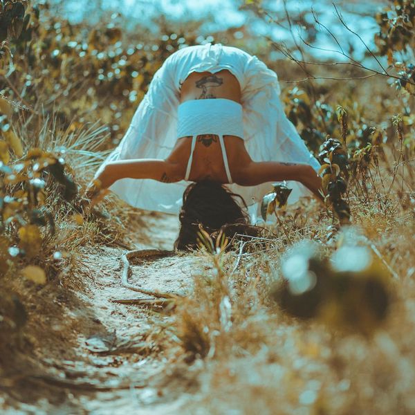 Person stretching outdoors, feeling energized and connected with nature.